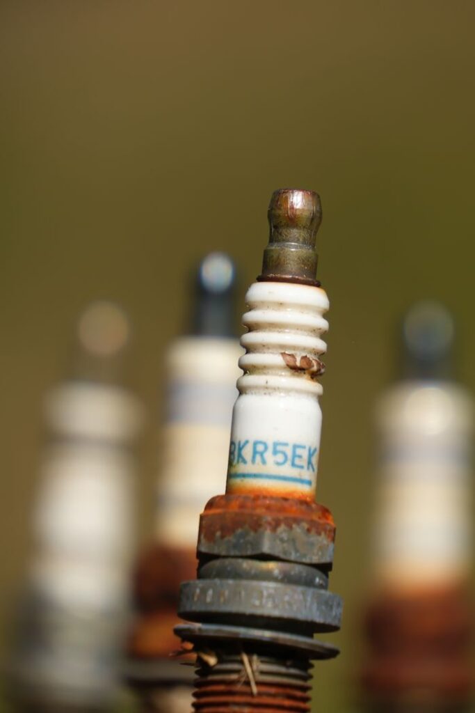 Detailed view of rusted spark plugs, showcasing industrial decay.